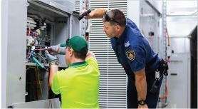 two workmen fixing the electrical board