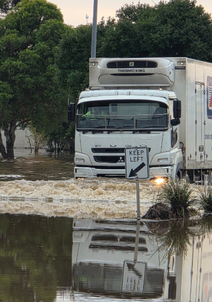 CSI Logistics truck driving through water