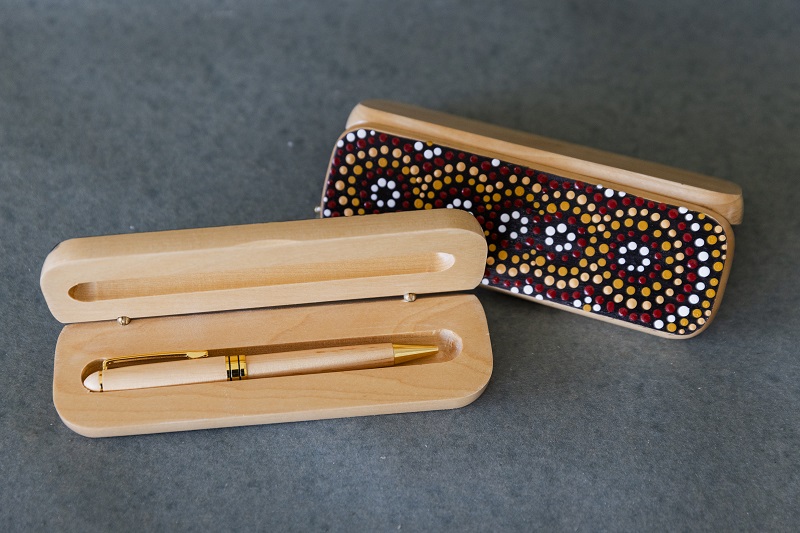 Wooden pen in a wooden case painted with an Aboriginal design