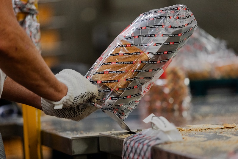 Freshly baked bread being packaged