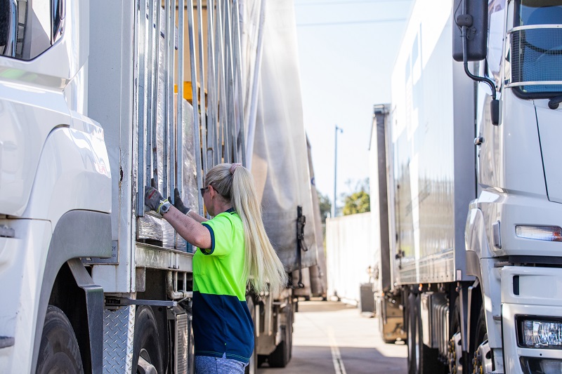 Person working alongside a logistics vehicle