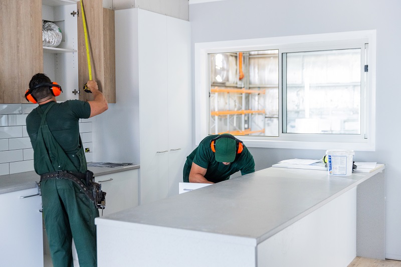 Inmate working with tools on kitchen installation