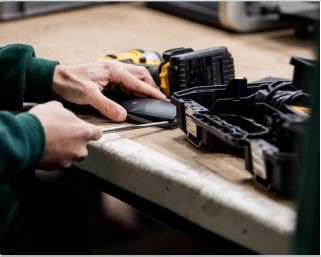 Someone with a toolbox assembling something