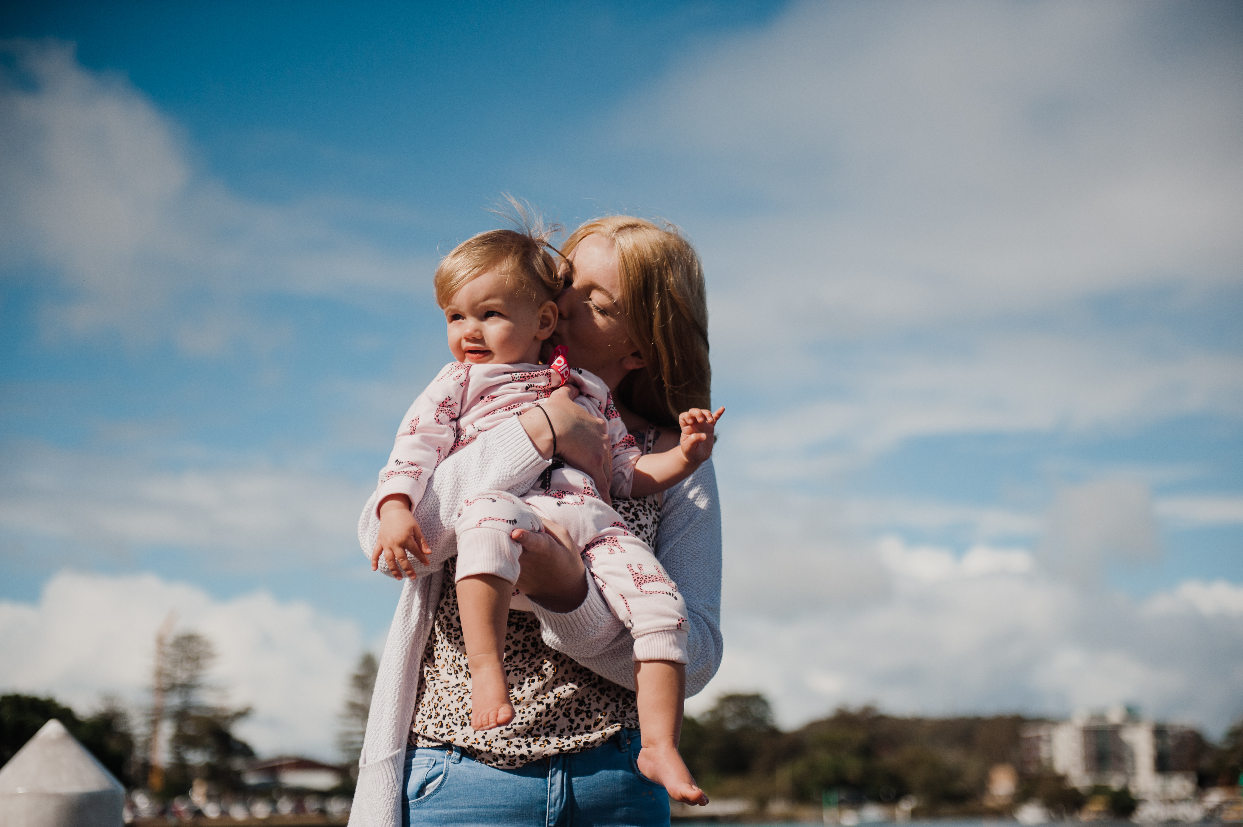 A mother cuddling her infant daughter